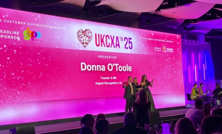 Donna O'Toole, Chair of Judges, on stage at the UK Customer Experience Awards 2025 to present an award