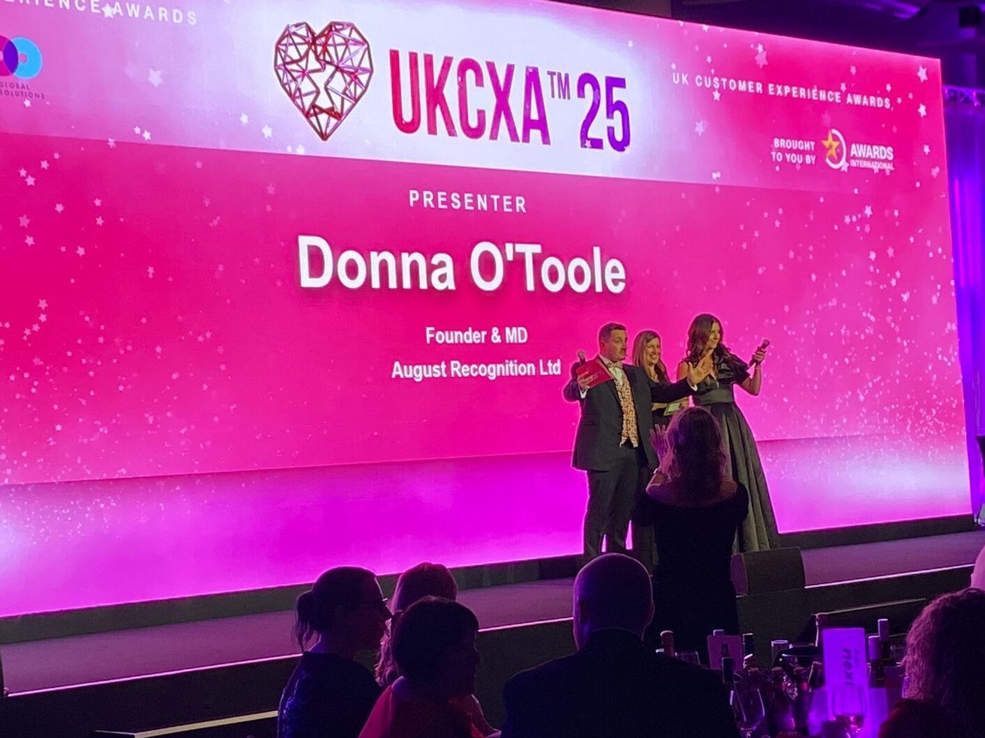 Donna O'Toole, Chair of Judges, on stage at the UK Customer Experience Awards 2025 to present an award